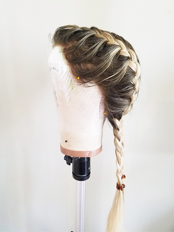 Profile view of styled/braided wig.